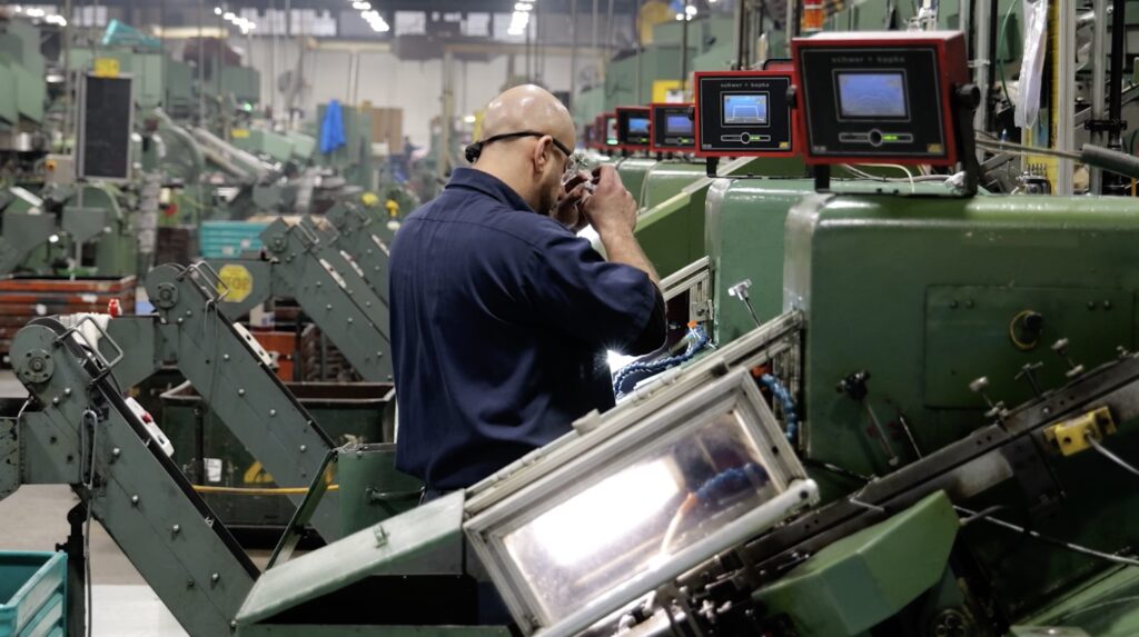 Close-up of fastener production mechanism at EJOT ATF factory